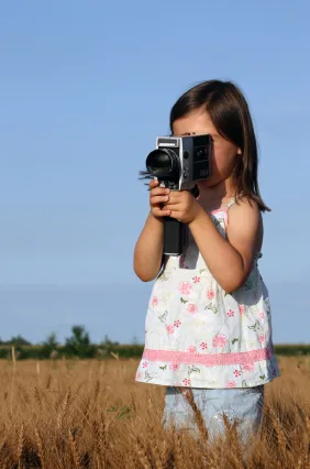Girl holding a movie camera - stock image to accompany movie review